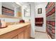 Bathroom features a wood vanity with light countertops and an illuminated mirror at 14867 E Harvard Ave, Aurora, CO 80014