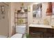 Functional bathroom featuring a shower, toilet, and vanity with stylish decor and practical storage solutions at 14867 E Harvard Ave, Aurora, CO 80014