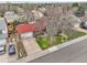 Real estate aerial view showcasing a landscaped yard and tree-lined front at 14867 E Harvard Ave, Aurora, CO 80014
