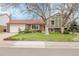Charming front yard with mature trees and a well-maintained lawn enhance this home's curb appeal at 14867 E Harvard Ave, Aurora, CO 80014