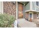Inviting front entrance with a classic door, brick accents, and charming decor, enhancing the home's curb appeal at 14867 E Harvard Ave, Aurora, CO 80014