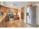 Spacious kitchen featuring stainless steel appliances, light countertops, and wood cabinets at 14867 E Harvard Ave, Aurora, CO 80014
