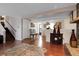 Spacious living room with staircase, decoratively furnished with wood accents and a plush rug at 14867 E Harvard Ave, Aurora, CO 80014