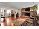 Cozy living room with brick fireplace, TV, plush rug, comfortable seating and decor at 14867 E Harvard Ave, Aurora, CO 80014