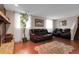 Cozy living room with fireplace, leather furniture, and natural light at 14867 E Harvard Ave, Aurora, CO 80014