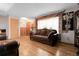 Comfortable living room featuring hardwood floors, a plush sofa, and ample natural light, creating a welcoming atmosphere at 14867 E Harvard Ave, Aurora, CO 80014