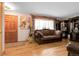 Cozy living room featuring hardwood floors, natural light, and comfortable seating for relaxing or entertaining at 14867 E Harvard Ave, Aurora, CO 80014