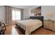 Serene main bedroom featuring hardwood floors, soft lighting, and a comfortable bed, creating a relaxing retreat at 14867 E Harvard Ave, Aurora, CO 80014