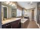 Relaxing bathroom featuring dual sinks, a soaking tub, a walk-in shower, and modern finishes at 2263 S Loveland St, Lakewood, CO 80228