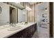 Bathroom with double sinks, modern lighting, and access to the bedroom at 2263 S Loveland St, Lakewood, CO 80228