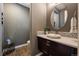 Stylish half-bathroom featuring modern fixtures, a decorative mirror, and wood look flooring at 2263 S Loveland St, Lakewood, CO 80228