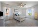 Bright bedroom with a cozy bed, two large windows, and warm, natural light at 2263 S Loveland St, Lakewood, CO 80228