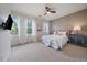 Bright bedroom with large windows, white curtains, and a comfortable bed, creating a serene atmosphere at 2263 S Loveland St, Lakewood, CO 80228