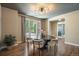 Bright dining room boasting a large table, hardwood floors, and a view of the lush outdoors at 2263 S Loveland St, Lakewood, CO 80228
