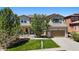 Charming two-story home featuring a well-manicured lawn, attached garage, and inviting front porch at 2263 S Loveland St, Lakewood, CO 80228