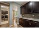 Hallway with dark cabinets and access to the laundry room and kitchen dining area at 2263 S Loveland St, Lakewood, CO 80228
