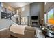 Bright living room boasting soaring ceilings, modern fireplace, and staircase with metal banisters at 2263 S Loveland St, Lakewood, CO 80228