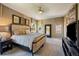 Spacious main bedroom with a plush king bed, designer decor, and a ceiling fan at 2263 S Loveland St, Lakewood, CO 80228