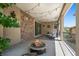 Outdoor patio with a fire pit, string lights, a stone accent wall, and comfortable seating at 2263 S Loveland St, Lakewood, CO 80228