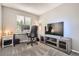 Neutral bedroom featuring a workspace with sleek desk and a modern entertainment center at 11864 N Chase Ct, Westminster, CO 80020