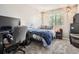Bedroom with desk, chair, computer, and a bed with a plush, blue blanket at 11864 N Chase Ct, Westminster, CO 80020