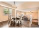 Bright dining room with hardwood floors and modern table with seating for six with an open view to the living room at 11864 N Chase Ct, Westminster, CO 80020
