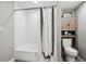 Cozy bathroom featuring a shower and tub combination and complemented by stylish fixtures and gray walls at 1390 Everett Ct # 105, Lakewood, CO 80215