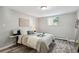 Inviting bedroom with a plush bed, stylish decor, and ample natural light, ideal for a restful retreat at 1390 Everett Ct # 105, Lakewood, CO 80215