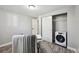 Bright bedroom featuring in-unit laundry, ample closet space, and modern decor for comfortable living at 1390 Everett Ct # 105, Lakewood, CO 80215