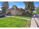 Two-story apartment building featuring well-maintained lawn and exterior stairs for upper units at 1390 Everett Ct # 105, Lakewood, CO 80215
