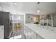 Open kitchen with stainless steel appliances, white cabinets, and ample counter space for cooking and entertaining at 1390 Everett Ct # 105, Lakewood, CO 80215