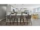 Bright kitchen with a large island with seating, stainless steel appliances, and modern finishes at 1390 Everett Ct # 105, Lakewood, CO 80215
