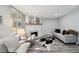 Comfortable living room featuring fireplace, stylish seating, and neutral tones at 1390 Everett Ct # 105, Lakewood, CO 80215