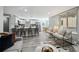 Open-concept living space featuring eat-in kitchen, island seating, and stylish decor at 1390 Everett Ct # 105, Lakewood, CO 80215