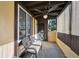 Covered porch featuring a rustic ceiling fan and a comfortable bench, perfect for relaxing outdoors at 1390 Everett Ct # 105, Lakewood, CO 80215