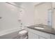 Clean bathroom features shower over tub and vanity with dark countertops at 1965 S Haleyville Way, Aurora, CO 80018