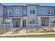 Beautiful townhome featuring stone accents, covered entry, and neat landscaping at 1965 S Haleyville Way, Aurora, CO 80018