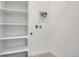 A functional laundry room features shelving and washer/dryer hookups at 1965 S Haleyville Way, Aurora, CO 80018
