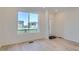 Bright living room with hardwood flooring, a large window, and a welcoming atmosphere at 1965 S Haleyville Way, Aurora, CO 80018