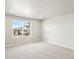 Bright bedroom offers neutral carpet and paint, plus a window to the community at 764 N Tempe St, Aurora, CO 80018