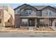 Charming townhome with brick accents, gray siding, and a welcoming front porch at 764 N Tempe St, Aurora, CO 80018