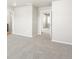 Bright room with open doorways, neutral paint, and plush gray carpeting at 764 N Tempe St, Aurora, CO 80018