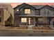 Modern townhome featuring a brick and gray facade with a covered front porch at 764 N Tempe St, Aurora, CO 80018