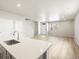 Open concept kitchen and living room area with bright white countertops and neutral colors at 764 N Tempe St, Aurora, CO 80018
