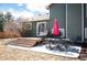 A backyard deck featuring an outdoor dining set, egg chair and a red patio umbrella at 200 N Holcomb St, Castle Rock, CO 80104