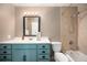 Bathroom with a blue vanity and a tiled shower-tub combination at 200 N Holcomb St, Castle Rock, CO 80104