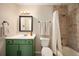 Bathroom with a green vanity and a tiled shower-tub combination at 200 N Holcomb St, Castle Rock, CO 80104