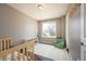 Charming bedroom featuring a crib, seating area, and soft natural light at 200 N Holcomb St, Castle Rock, CO 80104