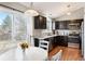 Modern kitchen with granite countertops, stainless steel appliances, hardwood floors, and sliding glass door to the yard at 200 N Holcomb St, Castle Rock, CO 80104