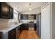 Beautiful kitchen featuring sleek stainless steel appliances, granite countertops, dark cabinets, and modern lighting at 200 N Holcomb St, Castle Rock, CO 80104